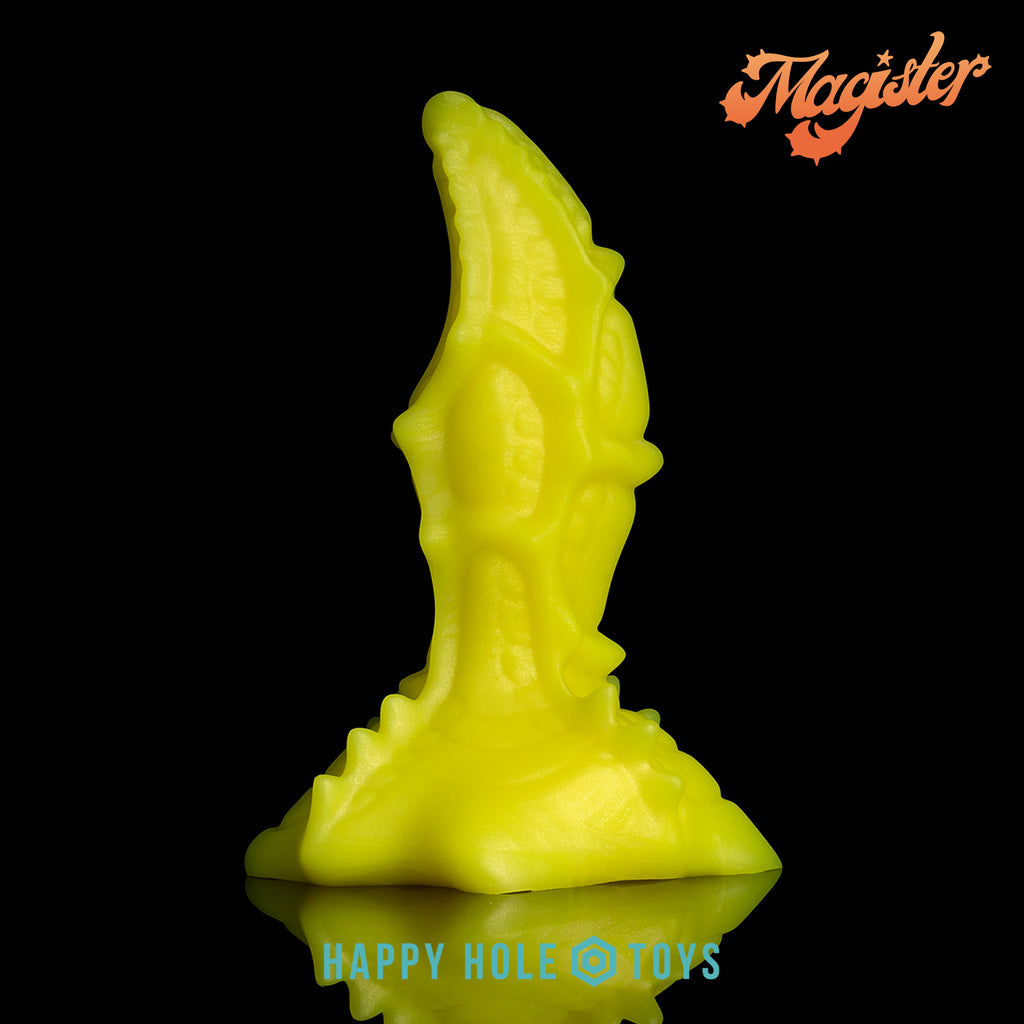 A Magister dildo in UV Sparkle Yellow, a vibrant yellow with mica swirls, on a black background. More in product description.